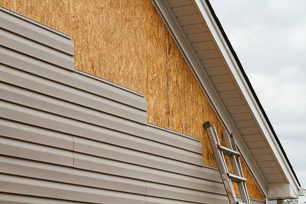 Professional Siding technician working in Saint James, NY